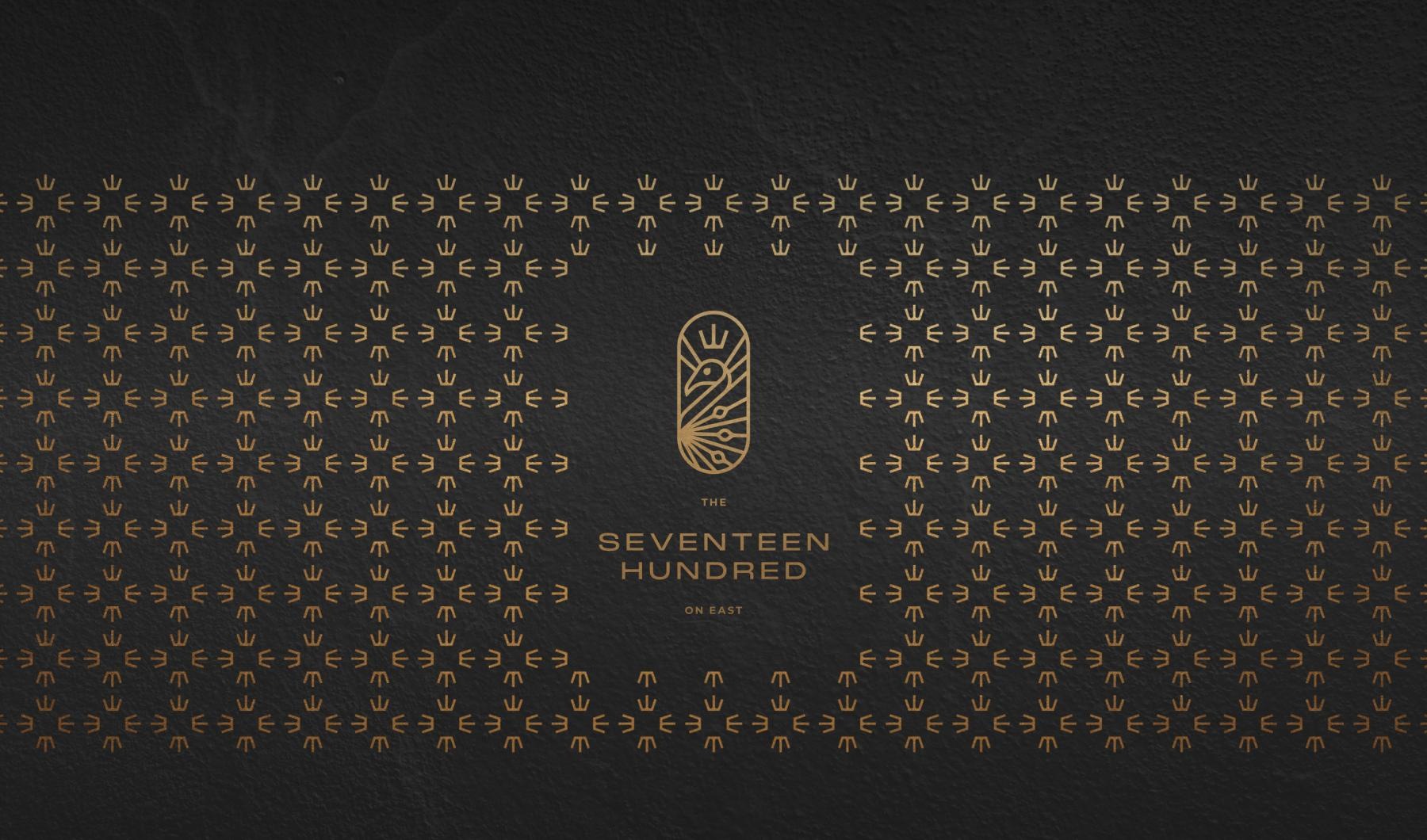 a logo over a gold pattern
