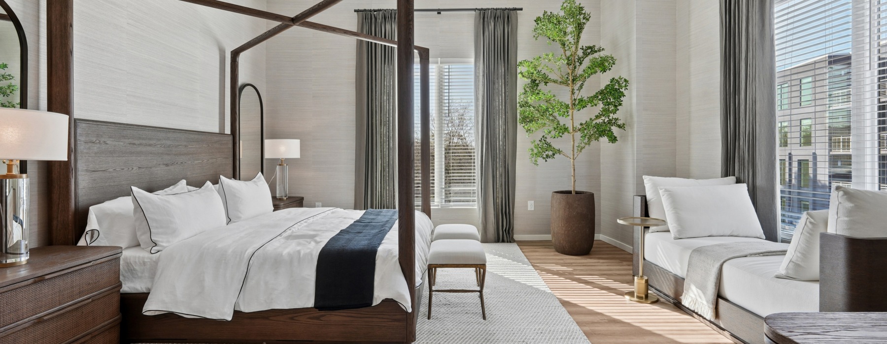 bedroom with large bed and tree in the corner